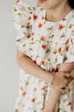 Girl’s Ivory Holly Print Christmas Dress with Ruffle Collar