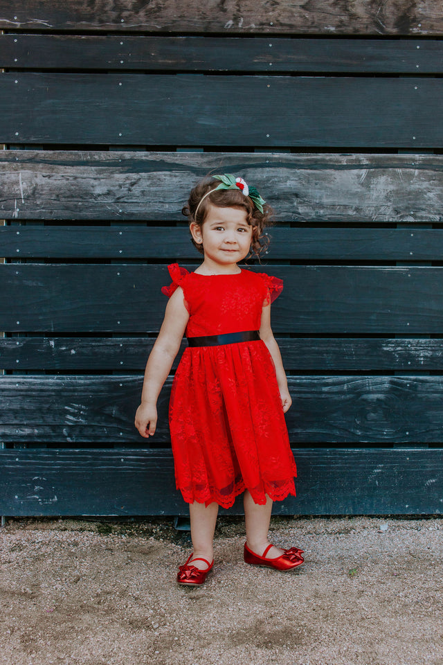 red lace special occasion dress with black satin sash